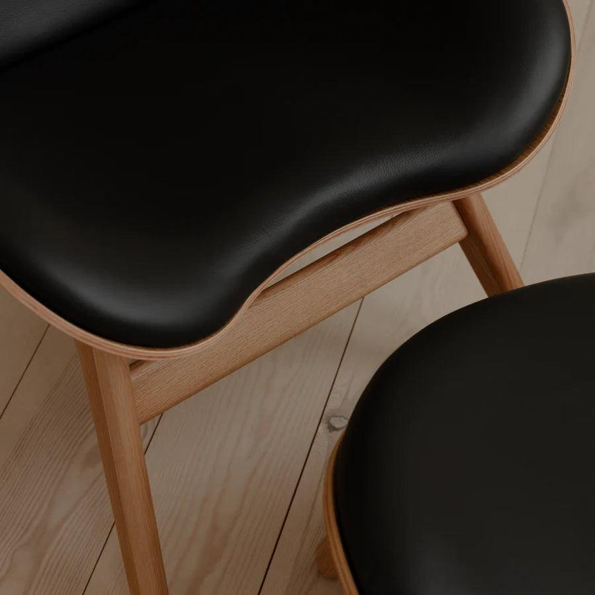 The Conversation Piece leather footstool with natural frame