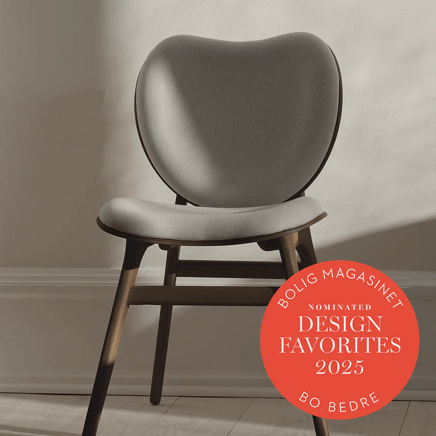 The Conversation Piece fabric armchair with natural frame