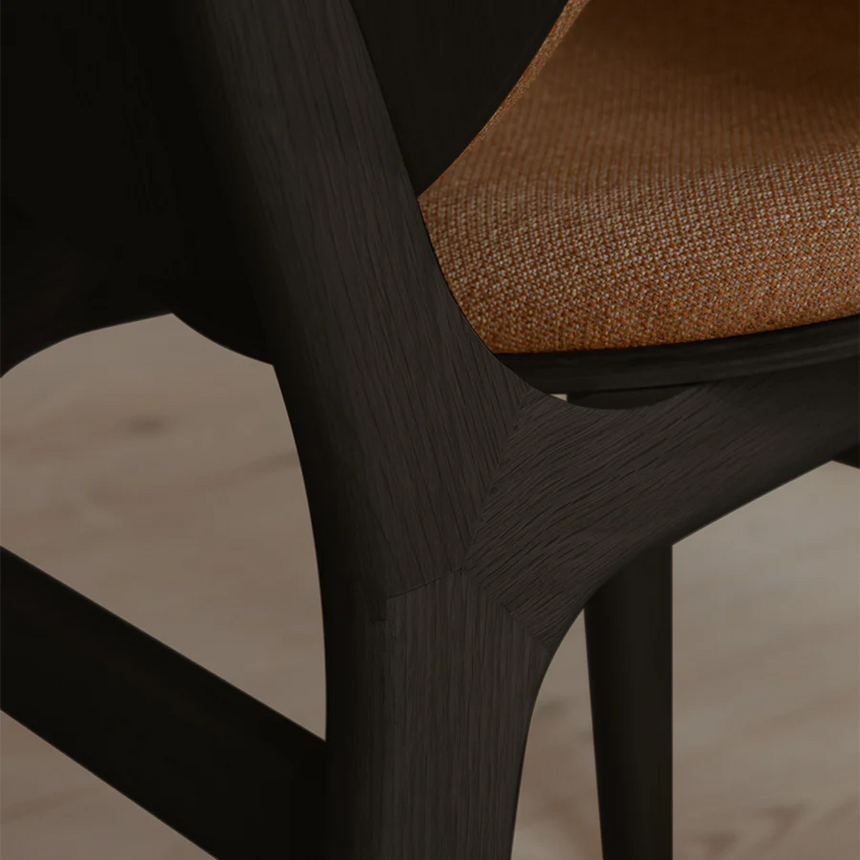 The Conversation Piece fabric armchair with natural frame