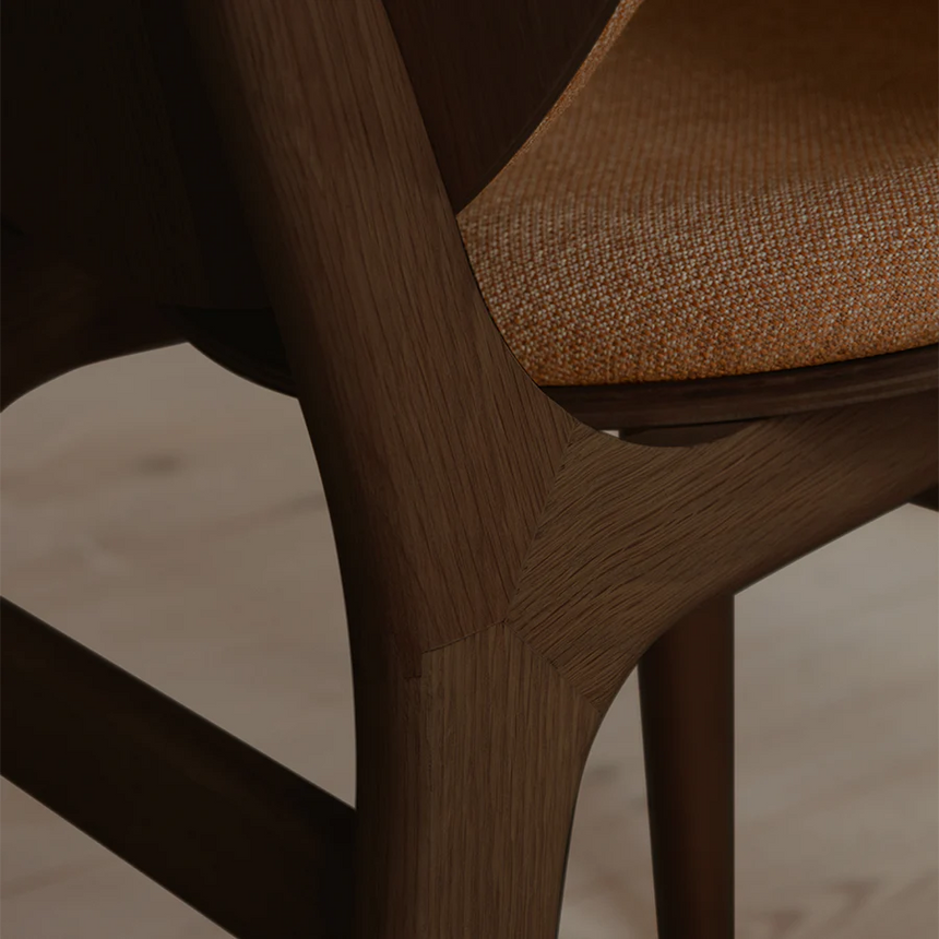 The Conversation Piece fabric armchair with natural frame