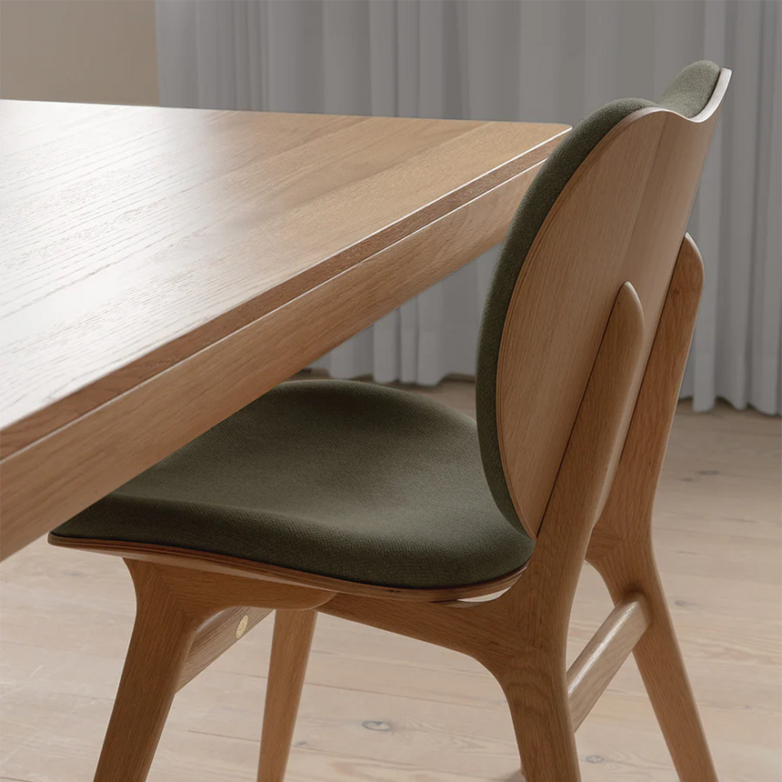 The Conversation Piece fabric armchair with natural frame