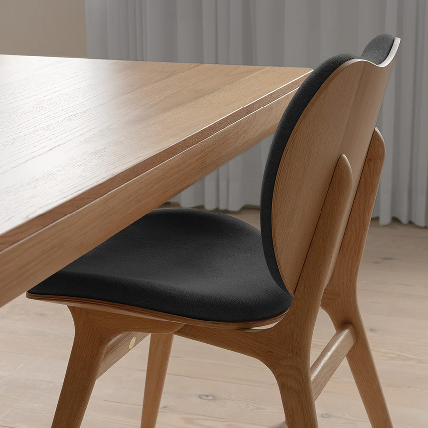 The Conversation Piece fabric armchair with natural frame