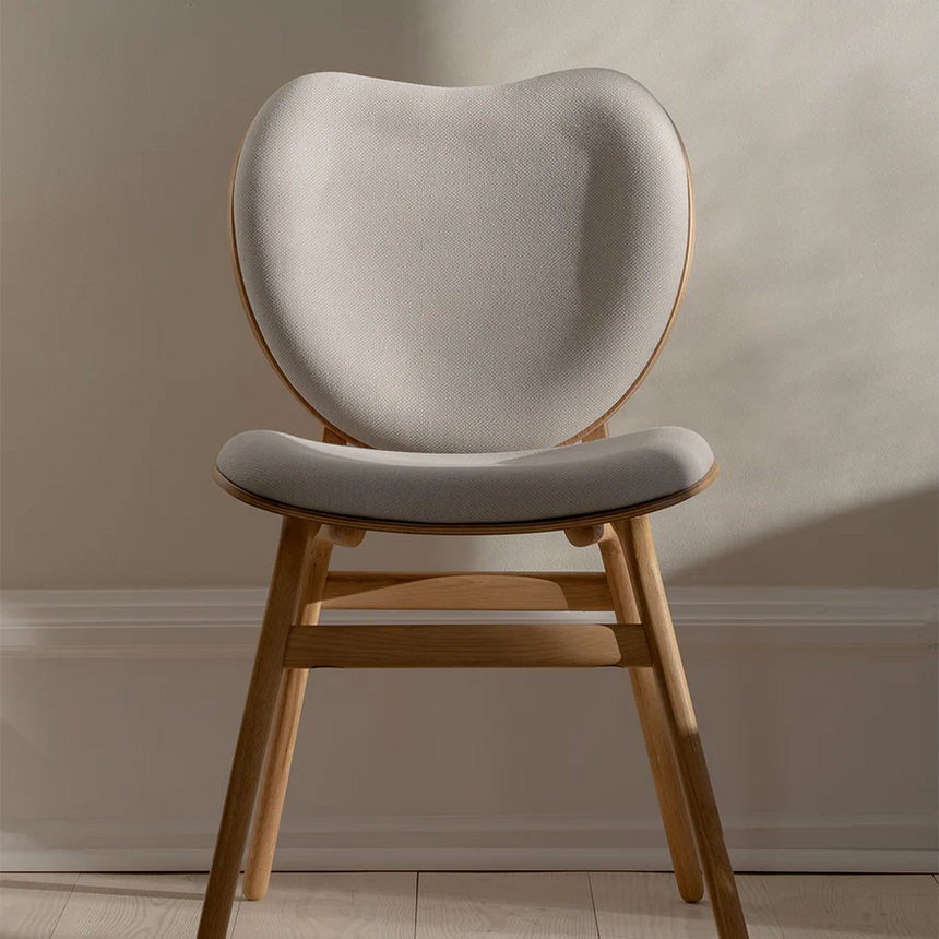 The Conversation Piece fabric armchair with natural frame