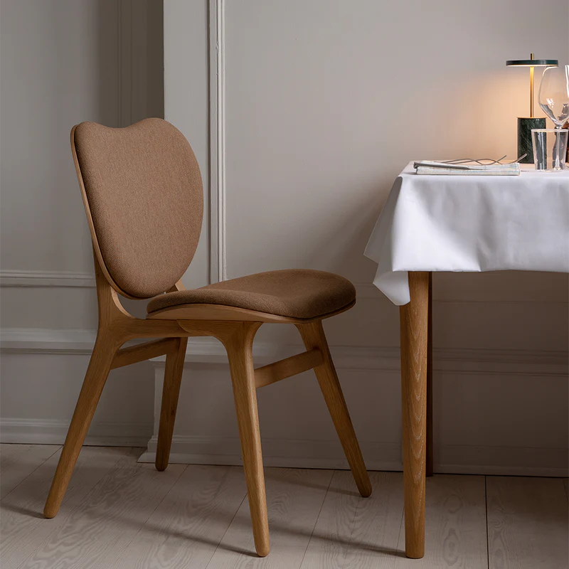 The Conversation Piece fabric armchair with natural frame