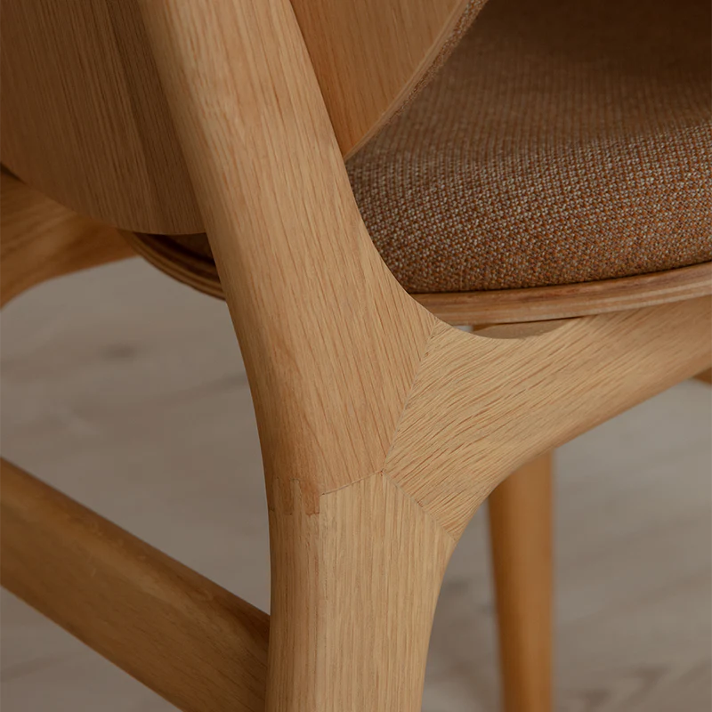 The Conversation Piece fabric armchair with natural frame