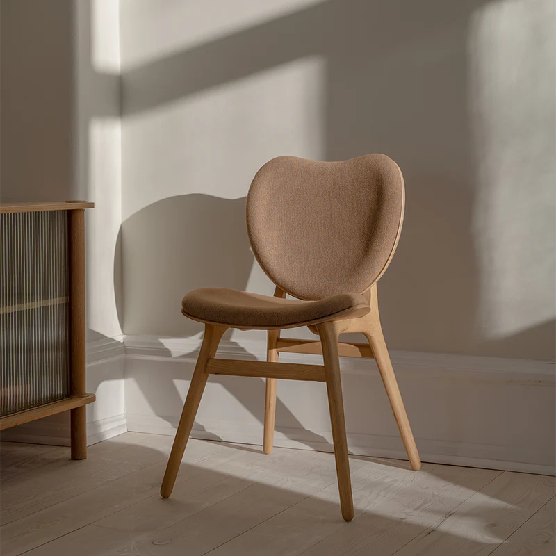 The Conversation Piece fabric armchair with natural frame