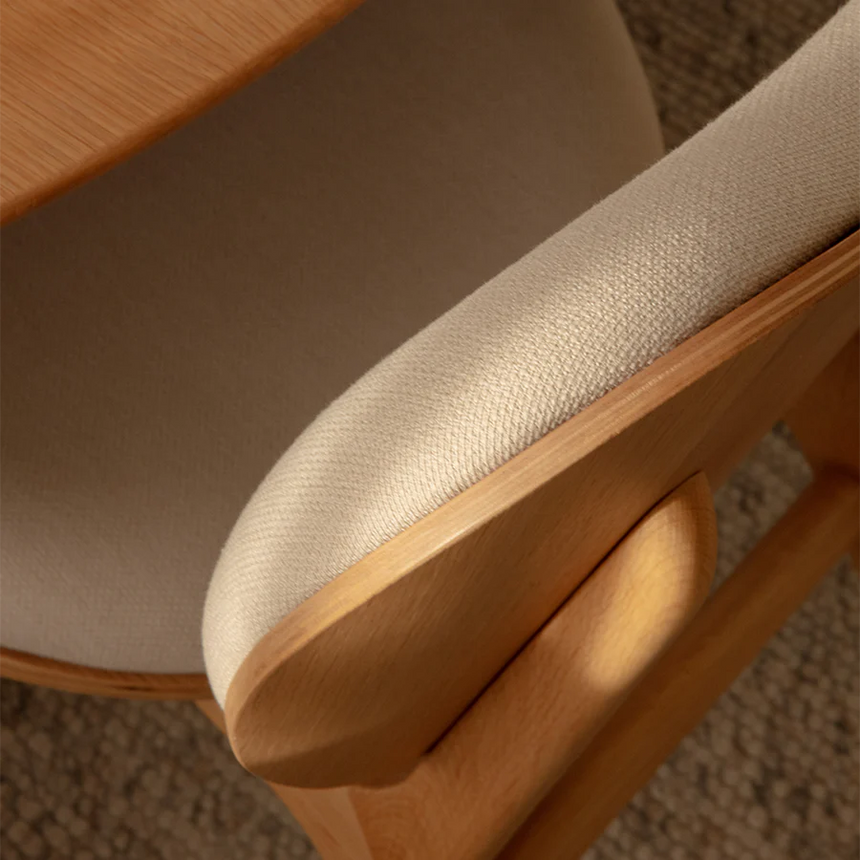 The Conversation Piece fabric armchair with natural frame