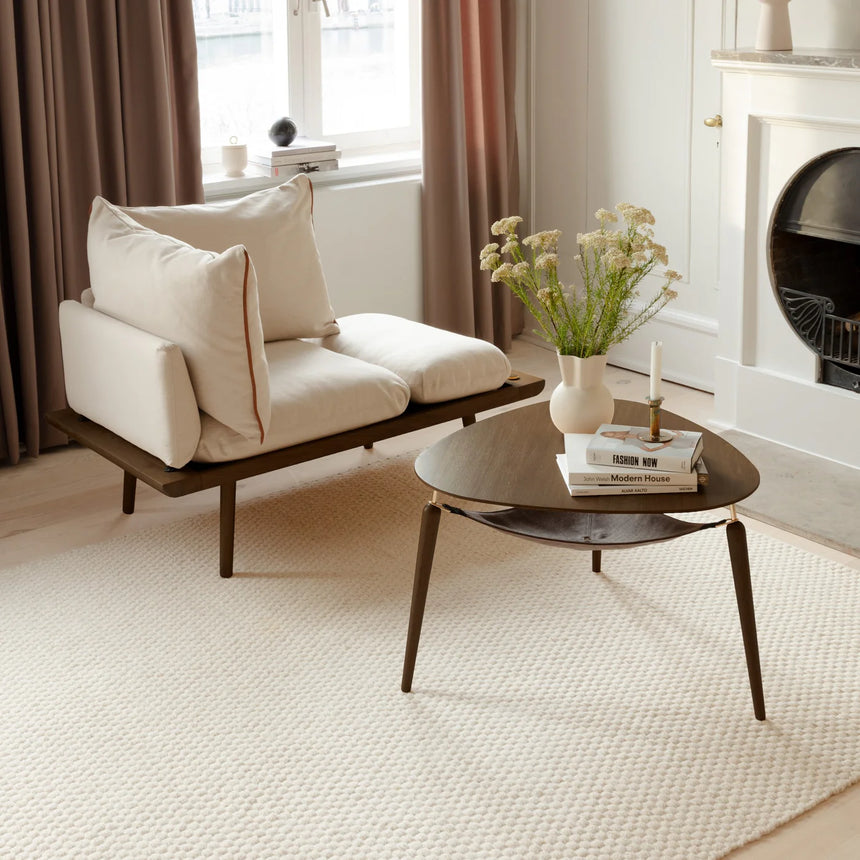 The Conversation Piece fabric armchair with natural frame