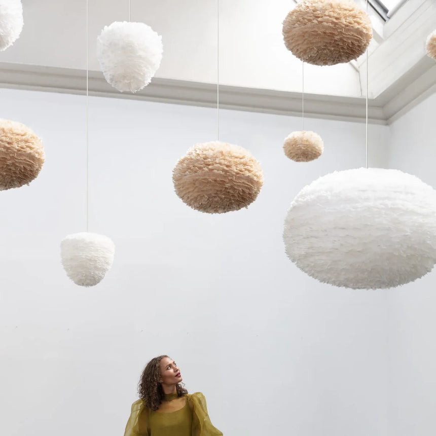 The Conversation Piece fabric armchair with natural frame