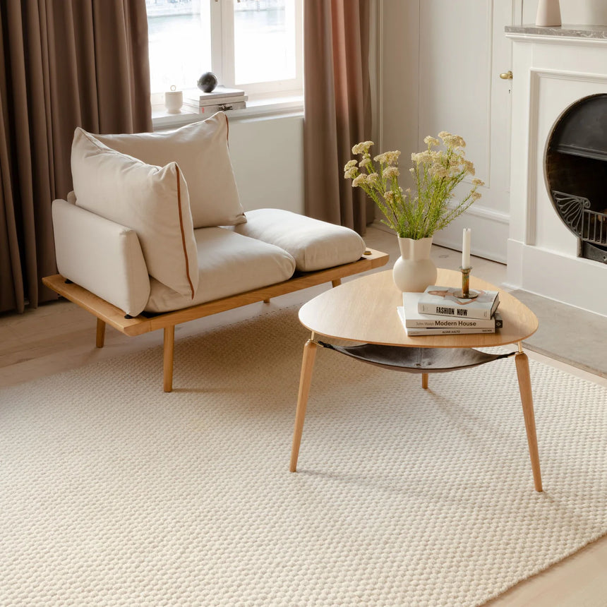 The Conversation Piece fabric armchair with natural frame