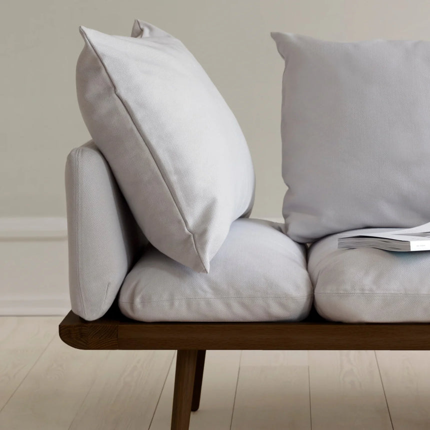 The Conversation Piece fabric armchair with natural frame