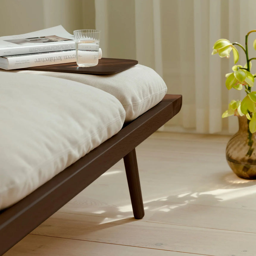 The Conversation Piece fabric armchair with natural frame