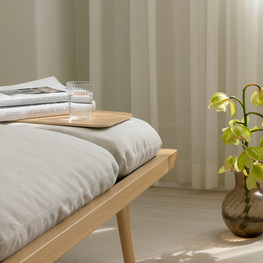 The Conversation Piece fabric armchair with natural frame