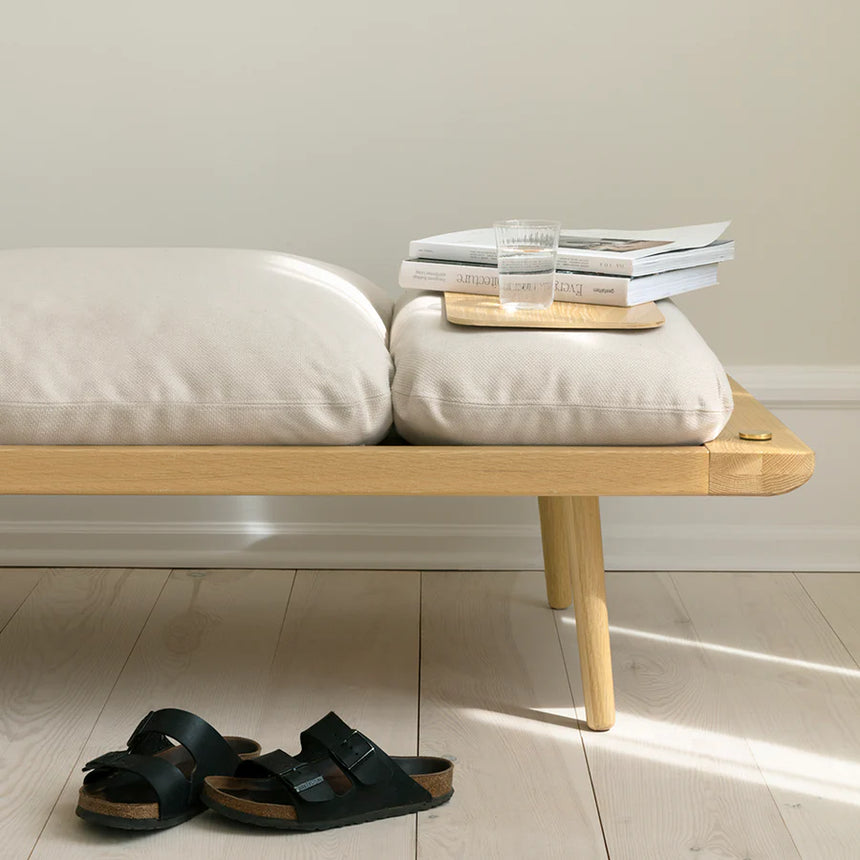 The Conversation Piece fabric armchair with natural frame