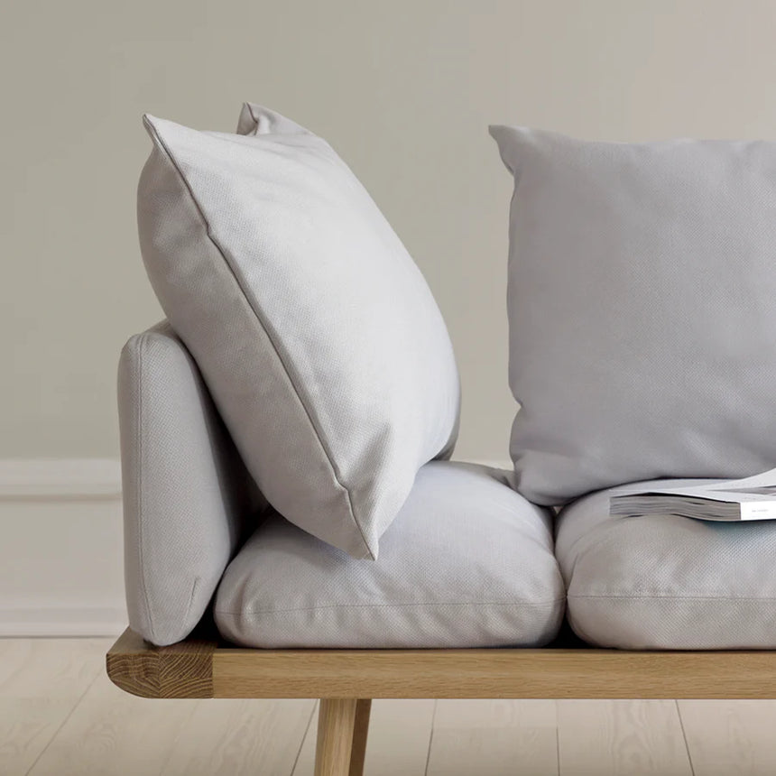 The Conversation Piece fabric armchair with natural frame