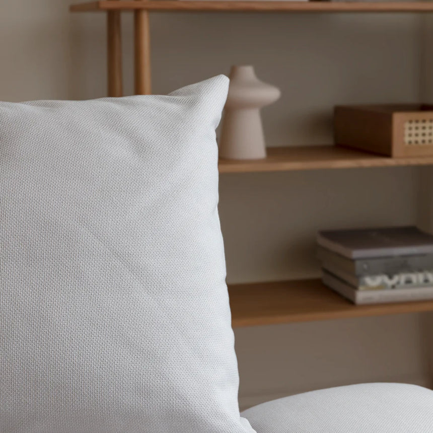 The Conversation Piece fabric armchair with natural frame