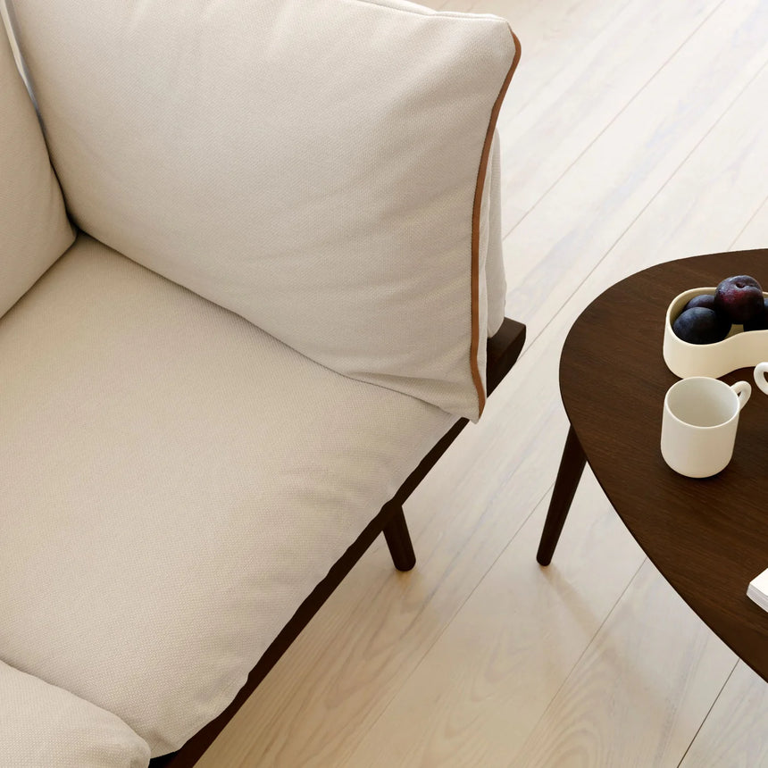 The Conversation Piece fabric armchair with natural frame