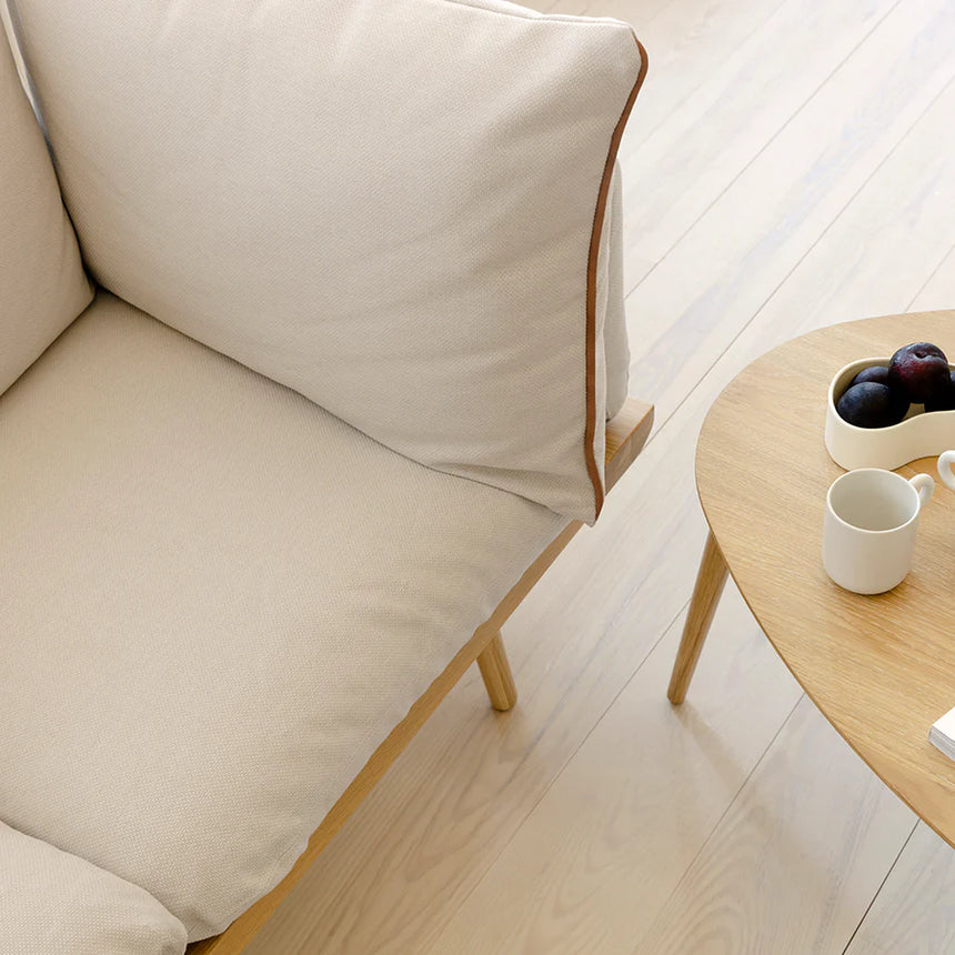 The Conversation Piece fabric armchair with natural frame