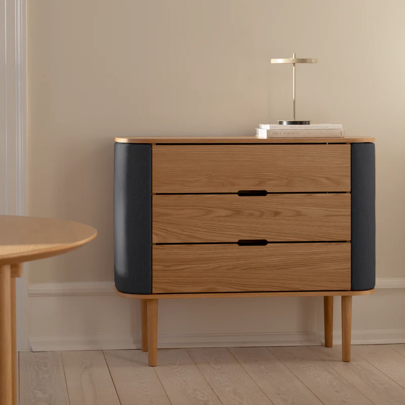 The Conversation Piece fabric armchair with natural frame