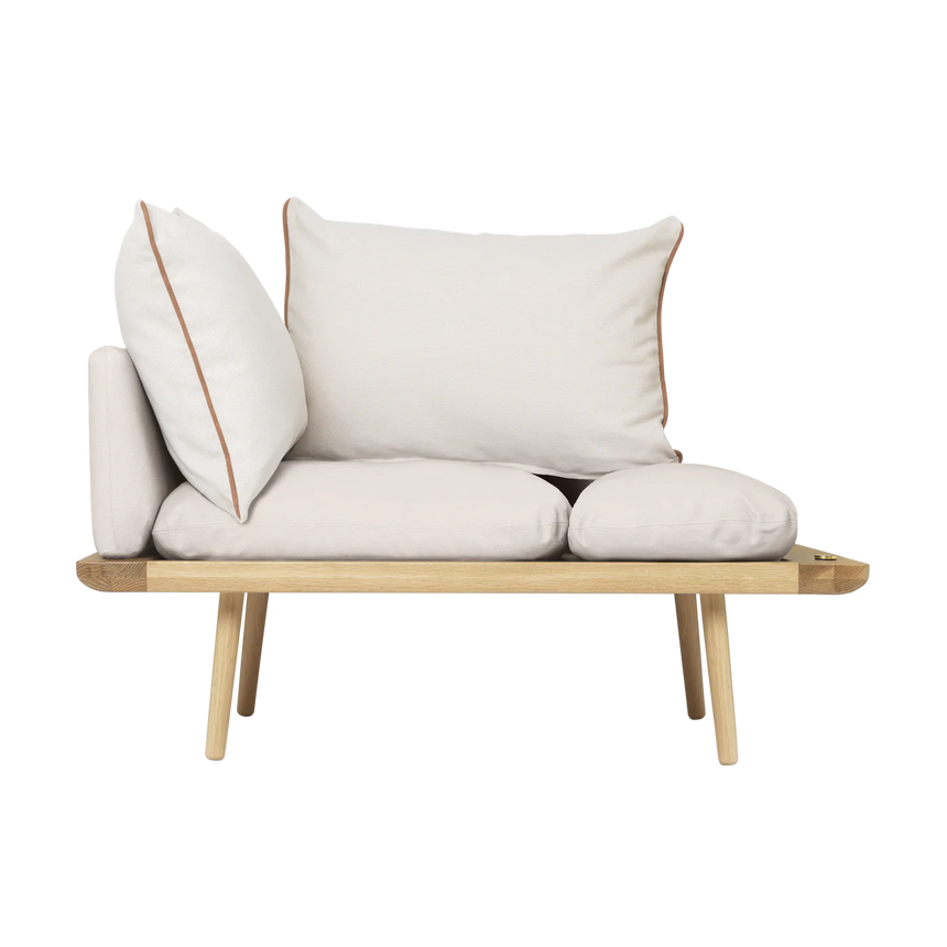 The Conversation Piece fabric armchair with natural frame