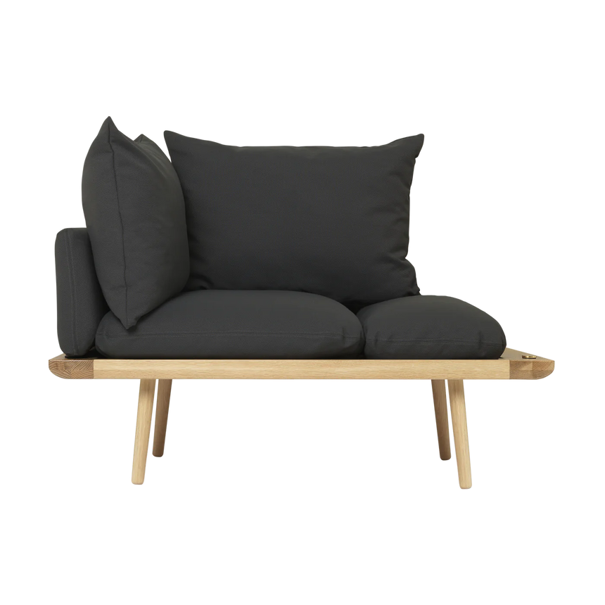 The Conversation Piece fabric armchair with natural frame