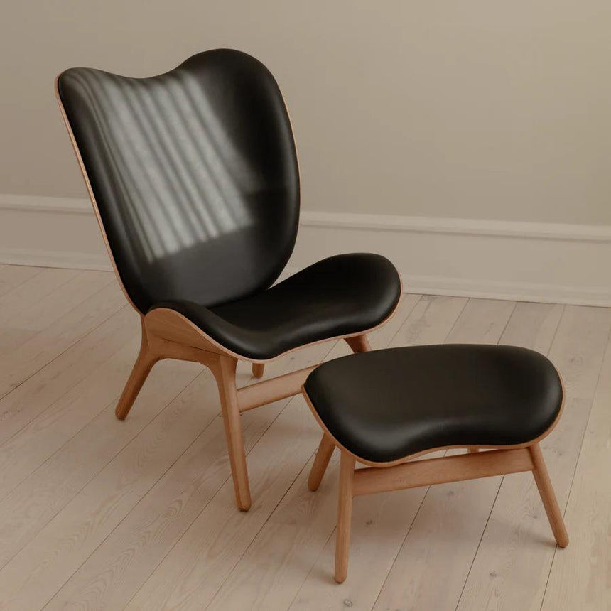 The Conversation Piece leather footstool with natural frame