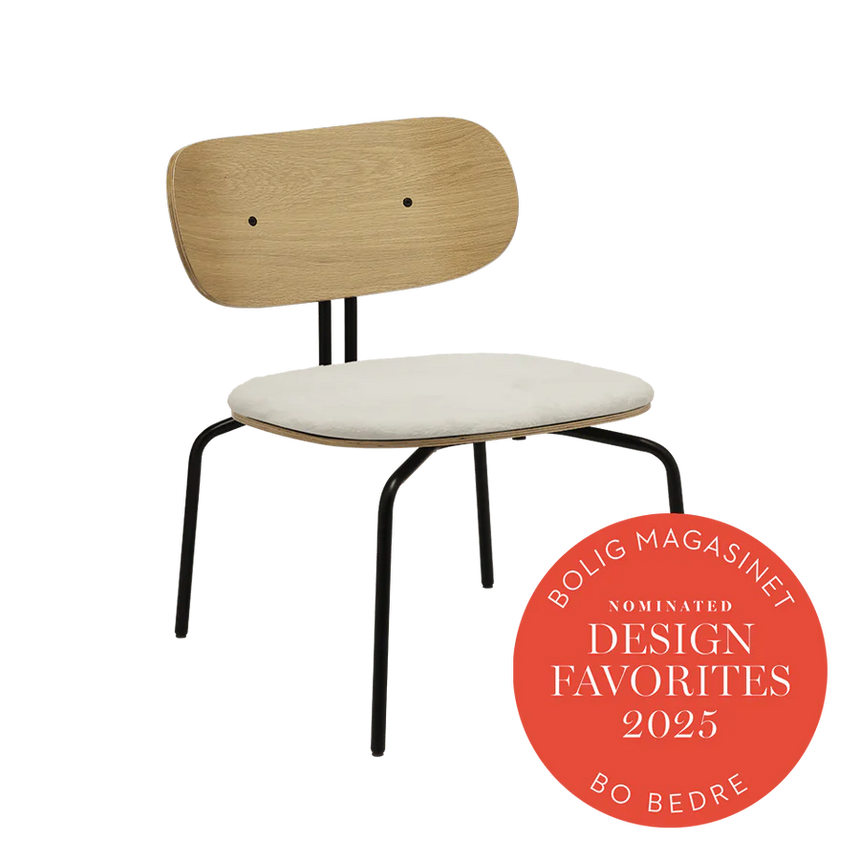 The Conversation Piece fabric armchair with natural frame