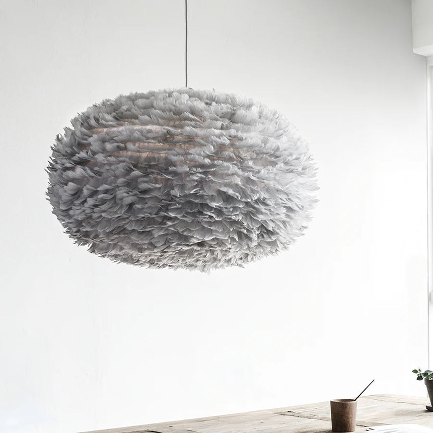 The Conversation Piece fabric armchair with natural frame