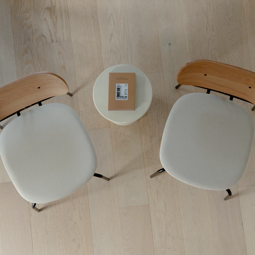 The Conversation Piece fabric armchair with natural frame