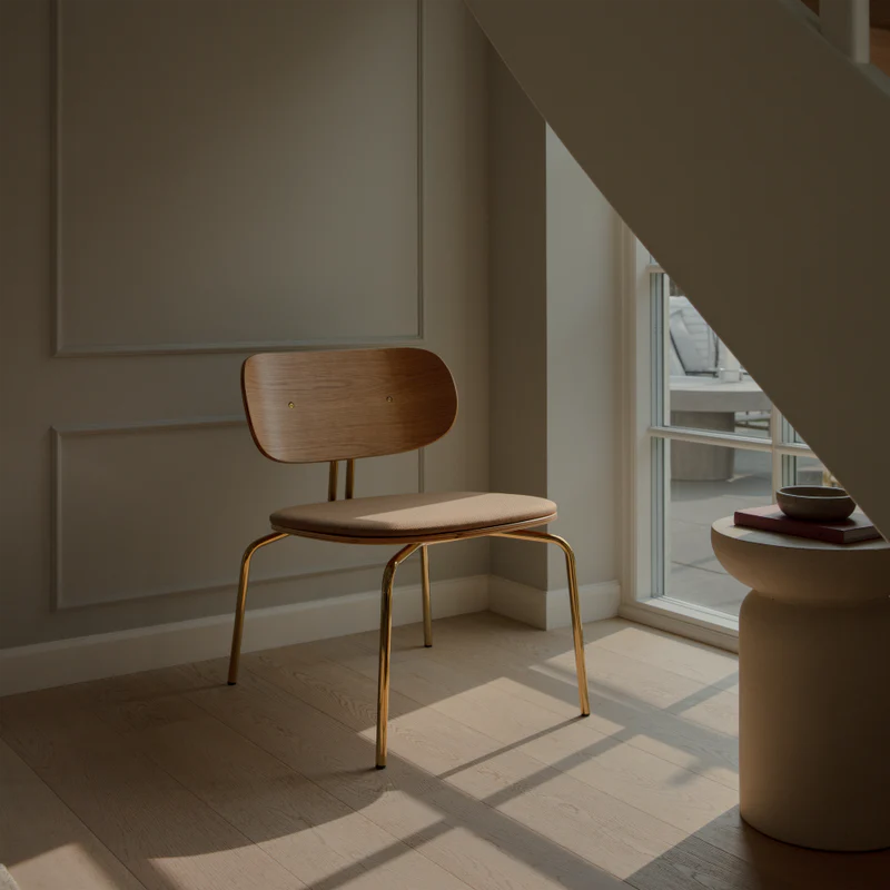 The Conversation Piece fabric armchair with natural frame