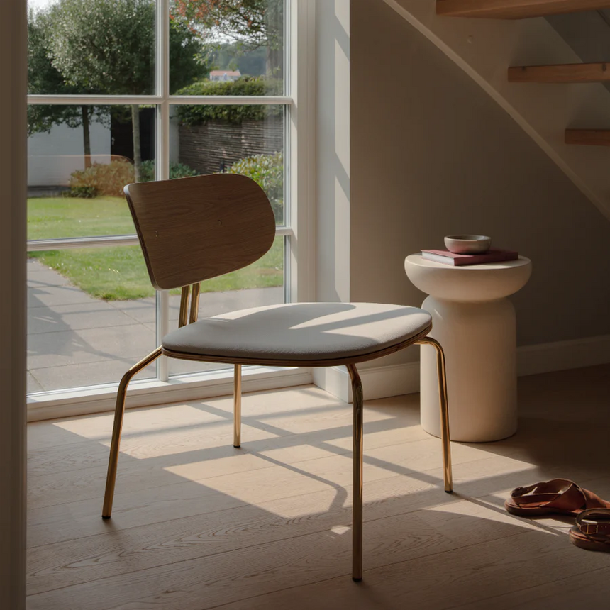The Conversation Piece fabric armchair with natural frame