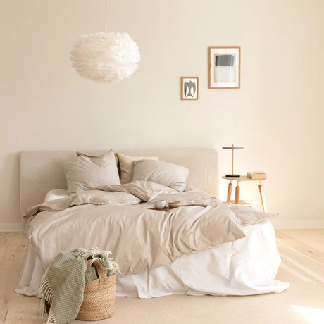 The Conversation Piece fabric armchair with natural frame
