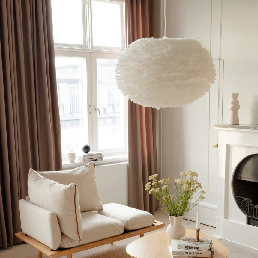The Conversation Piece fabric armchair with natural frame