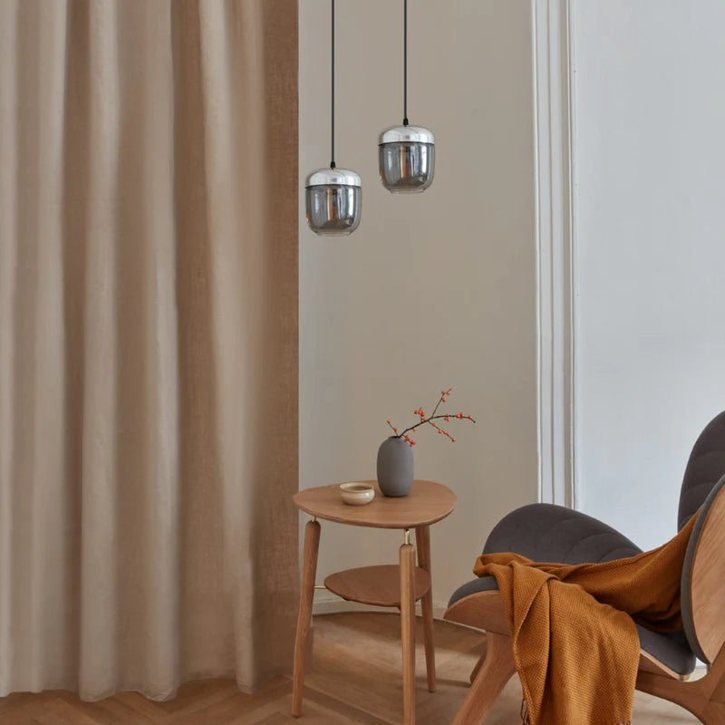 The Conversation Piece fabric armchair with natural frame