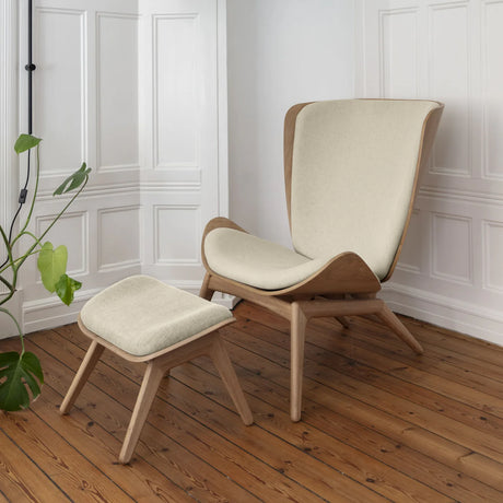 The Conversation Piece fabric armchair with natural frame