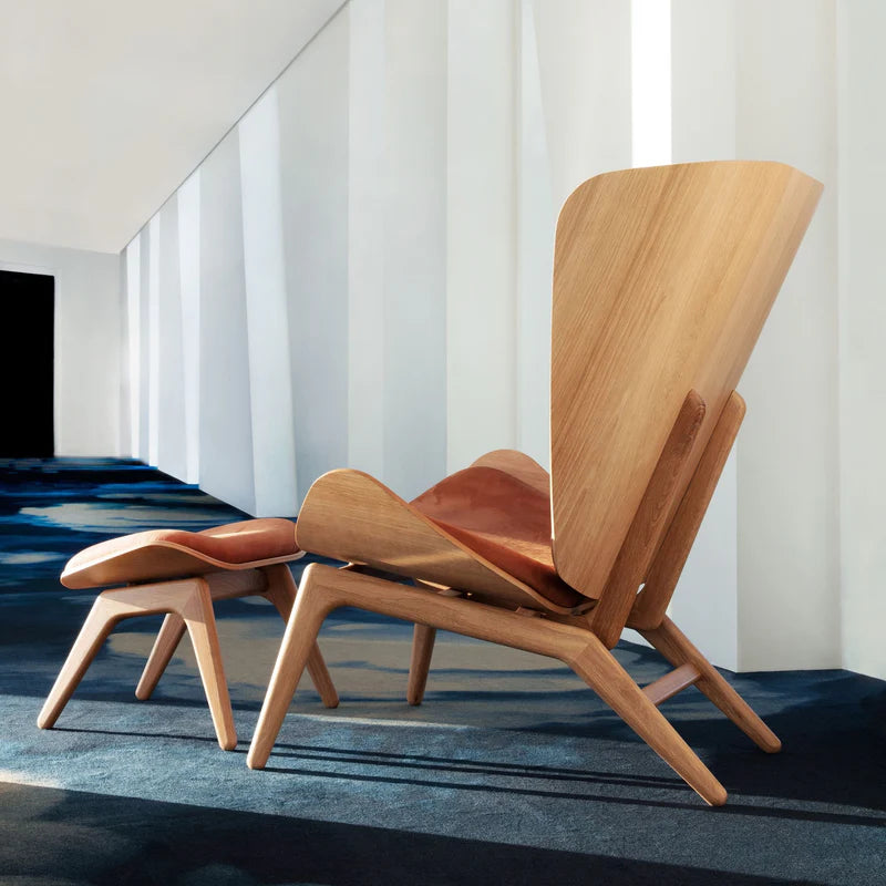 The Conversation Piece leather armchair with natural frame