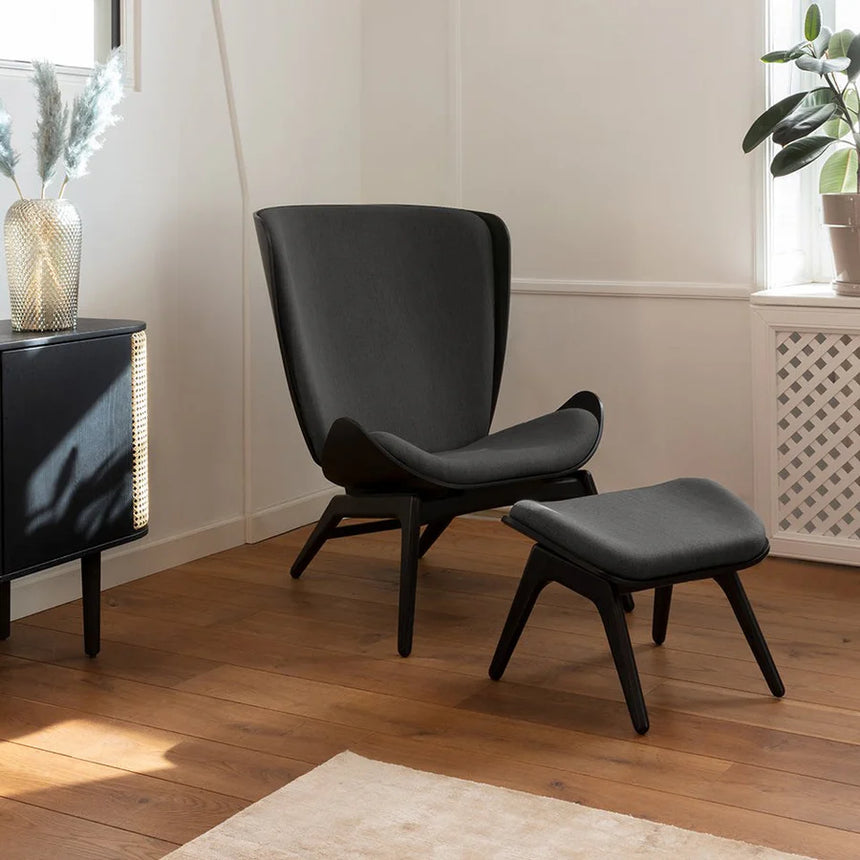 The Conversation Piece fabric armchair with natural frame
