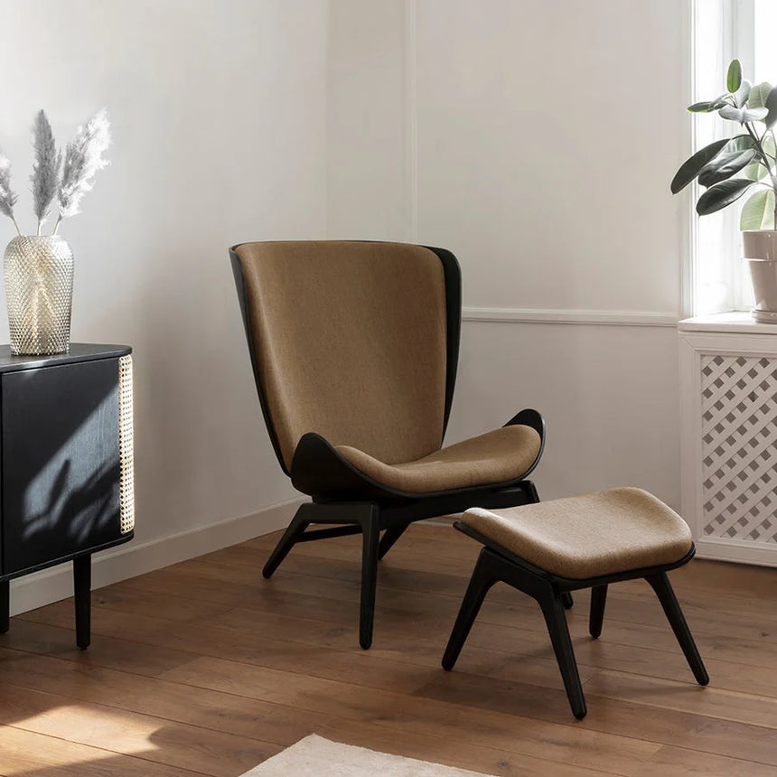 The Conversation Piece fabric armchair with natural frame