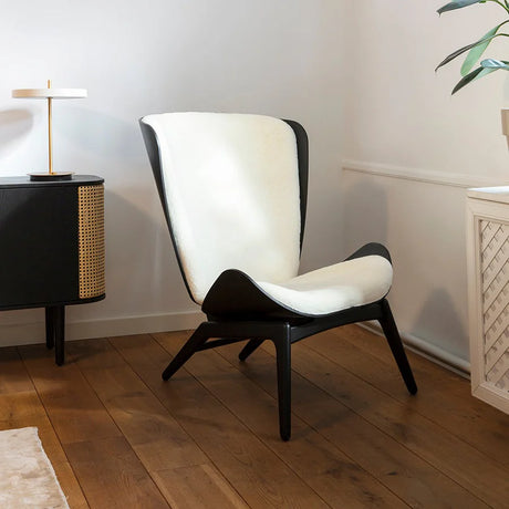 The Conversation Piece fabric armchair with natural frame