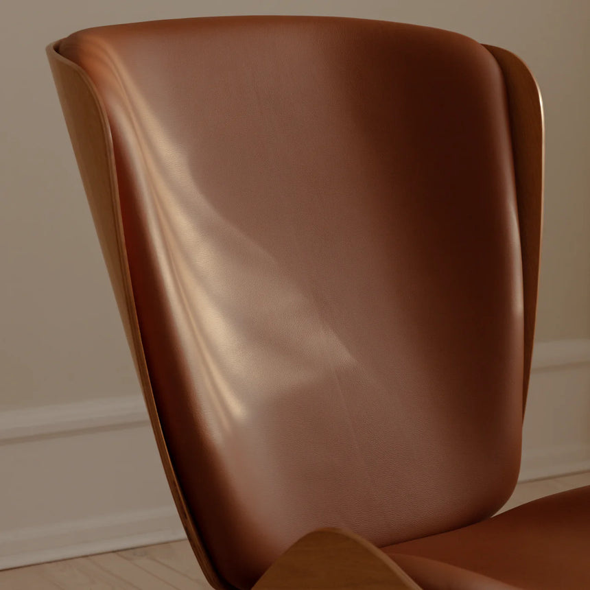 The Conversation Piece leather armchair with natural frame