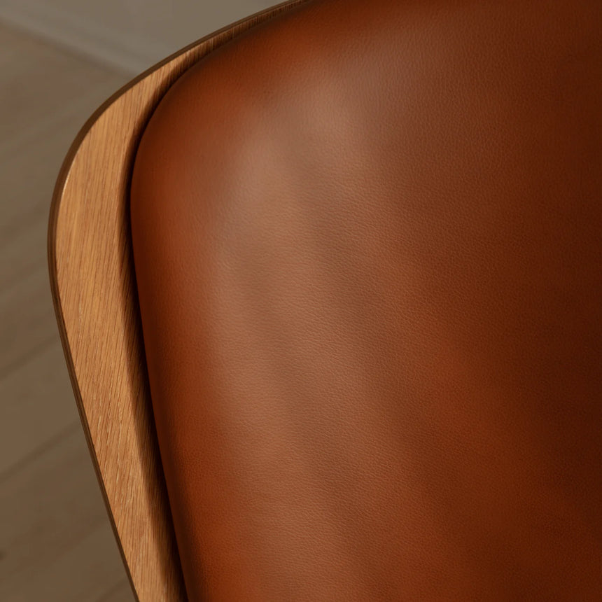 The Conversation Piece leather armchair with natural frame