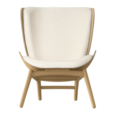 The Conversation Piece fabric armchair with natural frame