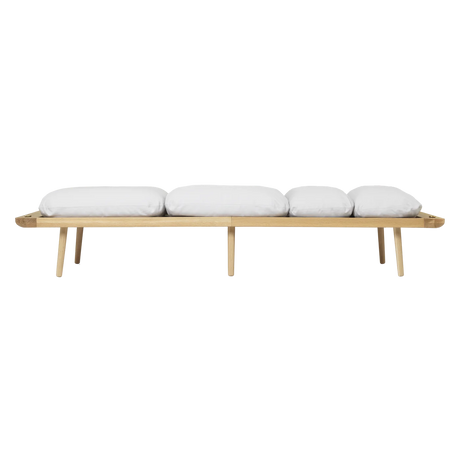 The Conversation Piece fabric armchair with natural frame