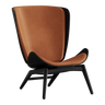 The Conversation Piece leather armchair with natural frame