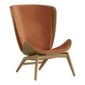 The Conversation Piece leather armchair with natural frame