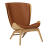 The Conversation Piece leather armchair with natural frame
