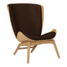 The Conversation Piece leather armchair with natural frame