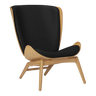 The Conversation Piece leather armchair with natural frame